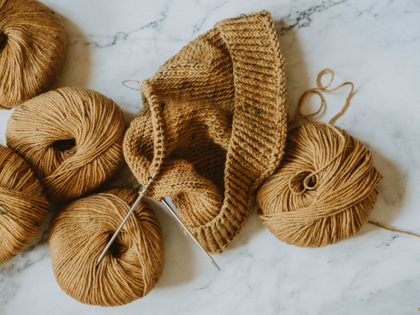 Brown yarn and a knitted panel on needles